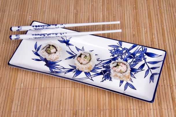 Sushi rolls on ceramic dishware - Fotó, kép