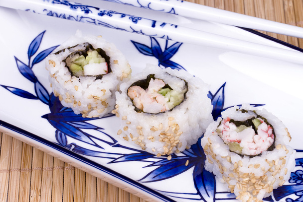 Sushi rolls on ceramic dishware - Φωτογραφία, εικόνα