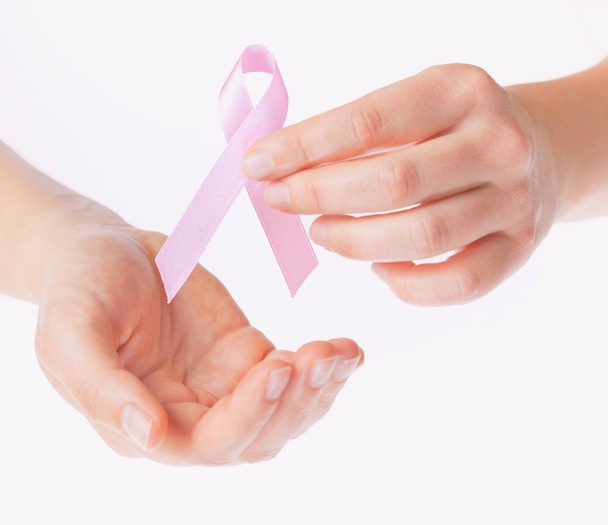 pink breast cancer awareness ribbon in gands - Foto, imagen