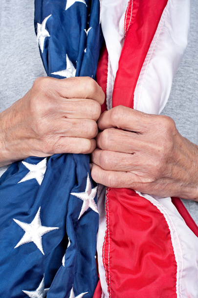 Elderly woman holding American flag - Foto, afbeelding