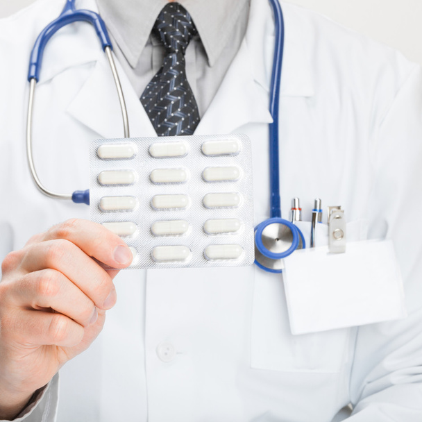 Доктор тримає таблетки в руці крупним планом
 - Фото, зображення