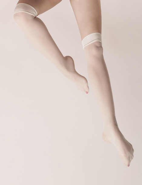 Female legs wearing parisian stockings and posing - Photo, Image