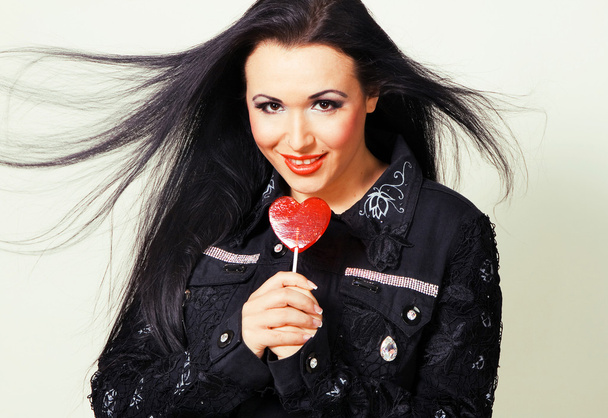 Lovely woman with a lollipop - Foto, Imagen