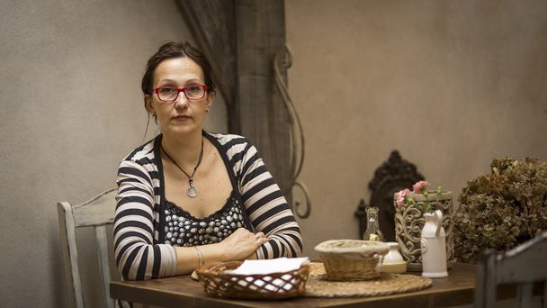 Woman sitting in old cafe-restaurant - Fotografie, Obrázek