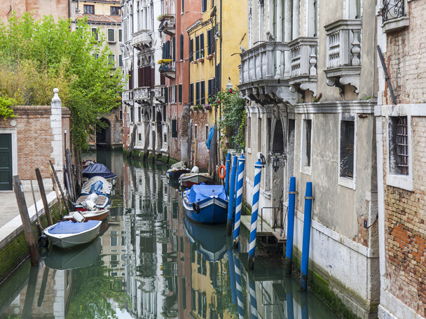 VENICE, ITALY - on MAY 1, 2015. Narrow street canal. Boats are moored near old houses - Фото, изображение