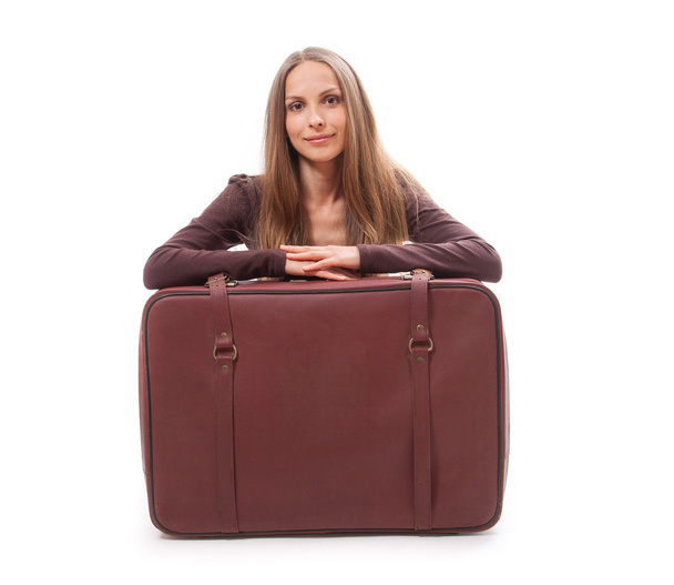 Girl sitting near a suitcase, isolated on white - Fotografie, Obrázek