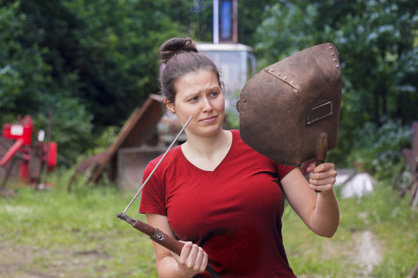 Girl in red with a welding machine - Fotó, kép