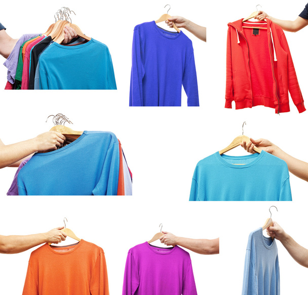 men hand holding hangers with sweaters and t-shirts - Photo, Image