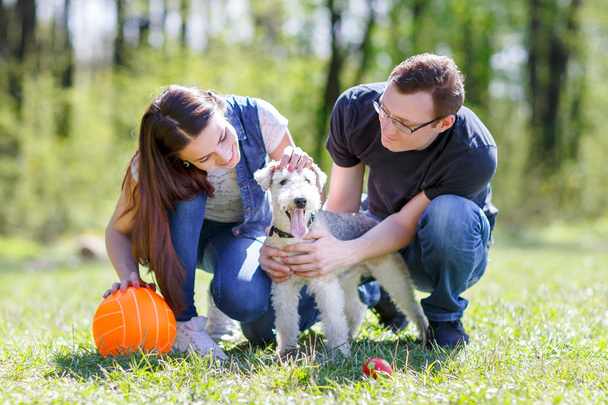 Happy young couple and  dog - Photo, Image