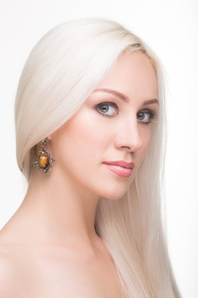 beautiful girl with long white hair and earrings. fashionable photo. portrait - 写真・画像