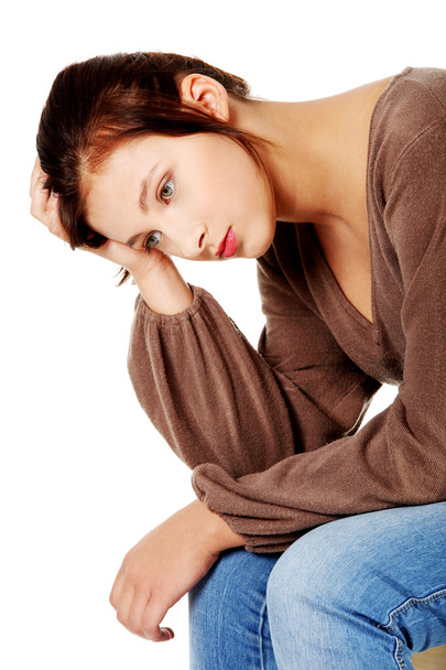 Sad teenage girl in depression thinking and touching her head. - Фото, зображення