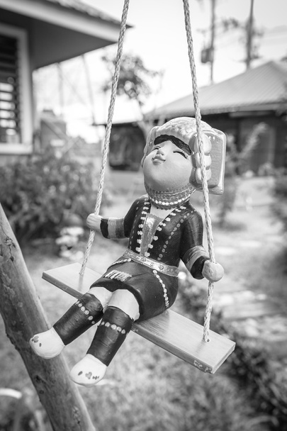 Ceramic doll hung swing in the garden - Photo, Image