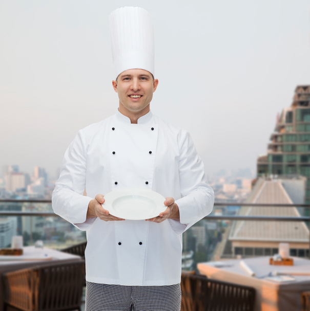 happy male chef cook showing empty plate - Zdjęcie, obraz