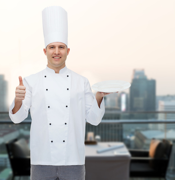 happy male chef cook showing thumbs up and plate - Фото, зображення