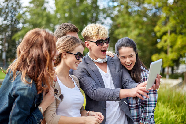 students or teenagers with tablet pc taking selfie - Foto, Imagen