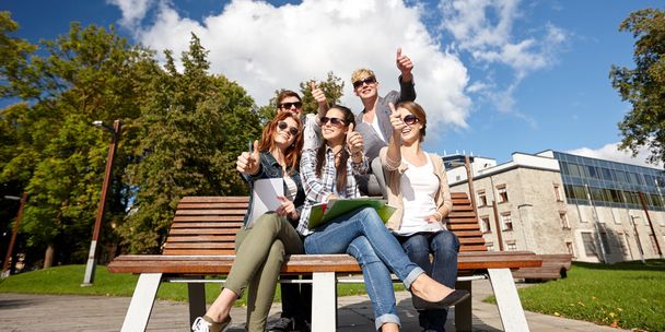 group of students or teenagers showing thumbs up - Foto, Bild