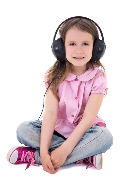 cute little girl listening music in headphones isolated on white - Foto, afbeelding