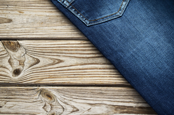 jeans on wooden background top corner. horizontal - Фото, изображение