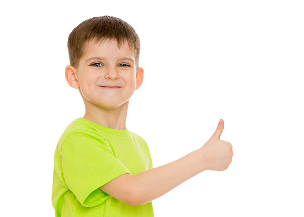 Boy smiling making the hand gesture moves or hitchhiking - Fotó, kép