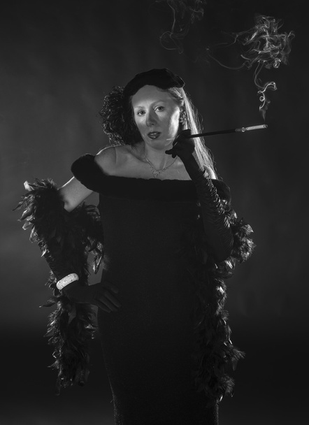 Glamorous 1940s Film Noir Woman Smoking Cigarette - 写真・画像