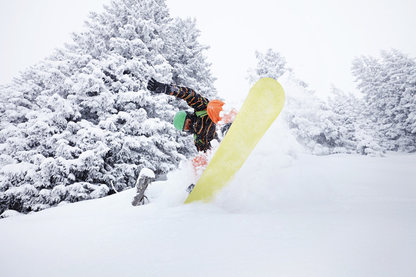 Snowboarder jumping on ski slope - Photo, Image