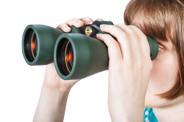 girl looks through binoculars isolated on white - Photo, image