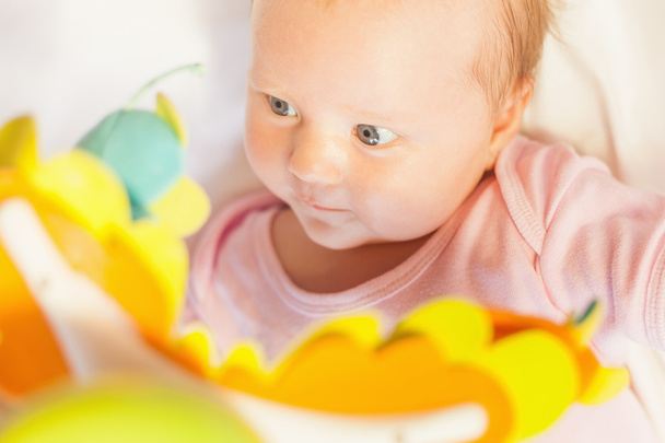 happy baby playing with children's musical mobile toy - Fotoğraf, Görsel