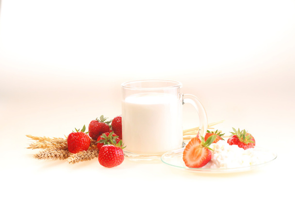 Milk and strawberry on a white background, milk in a transparent - Fotografie, Obrázek