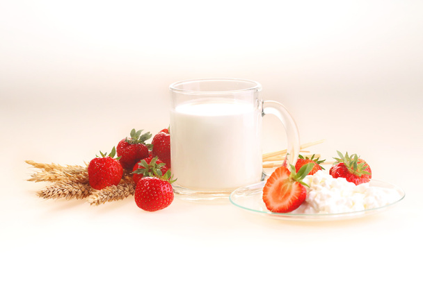 Milk and strawberry on a white background, milk in a transparent - Foto, Bild