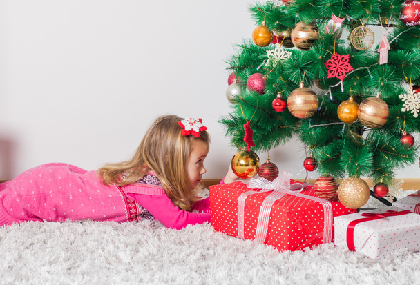 Happy Little Girl with Christmas Gift - Фото, зображення