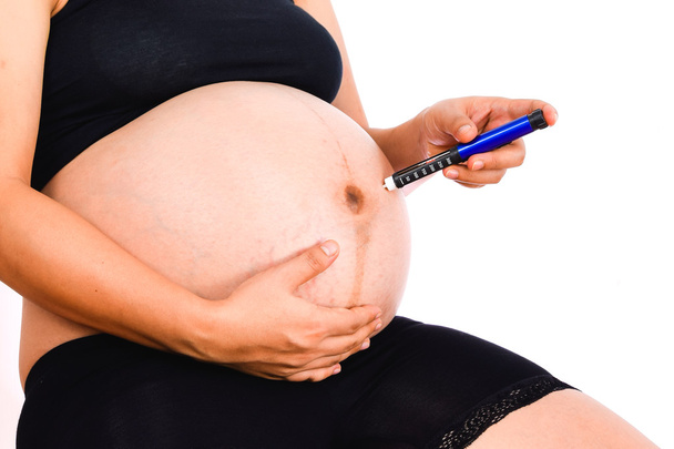 Pregnant woman with syringe insulin in hand on white background - Fotoğraf, Görsel