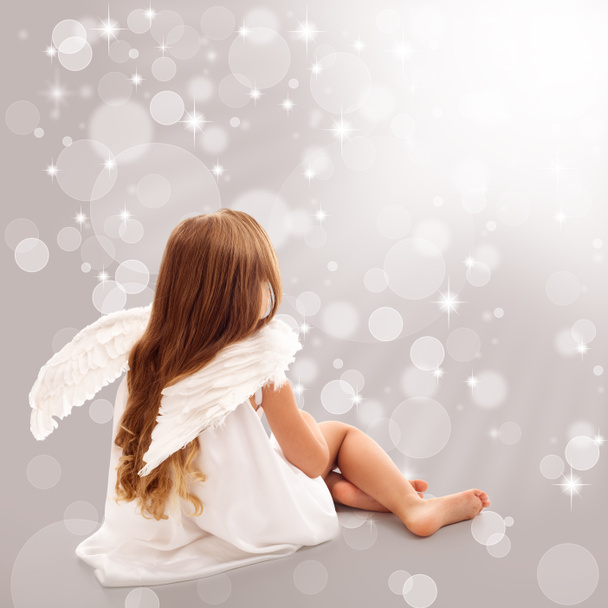 Little angel thinking in divine light - Фото, изображение