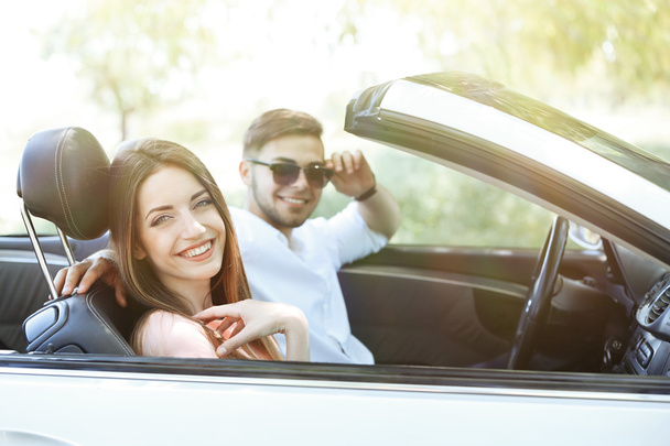 Young couple in cabriolet, outdoors - Fotografie, Obrázek
