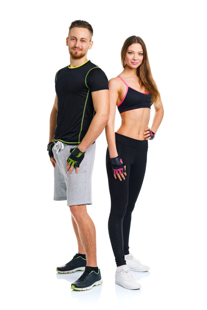 Sport couple - man and woman after fitness exercise on the white - 写真・画像