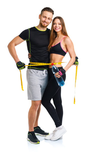 Happy sport couple - man and woman with measuring tape on the wh - Photo, Image