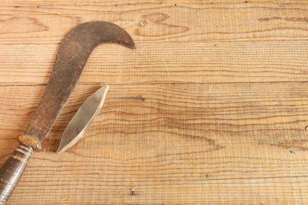 dated and used billhooks on wooden background - 写真・画像