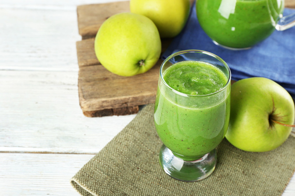 Healthy green smoothie with apples on wooden table, closeup - Fotó, kép