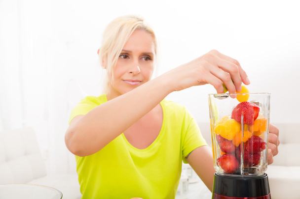 Mature woman blending a smoothie					 - Photo, Image