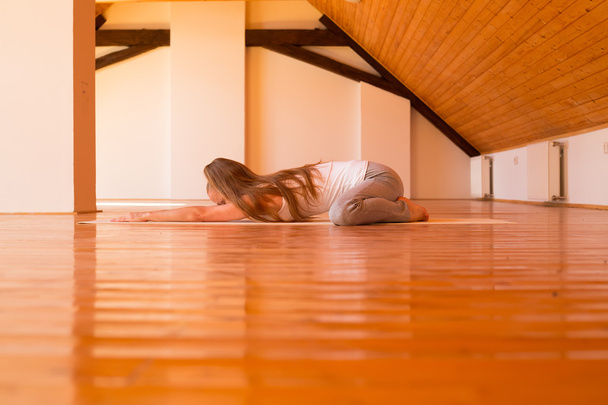 Woman practicing Yoga in a Studio - Foto, afbeelding