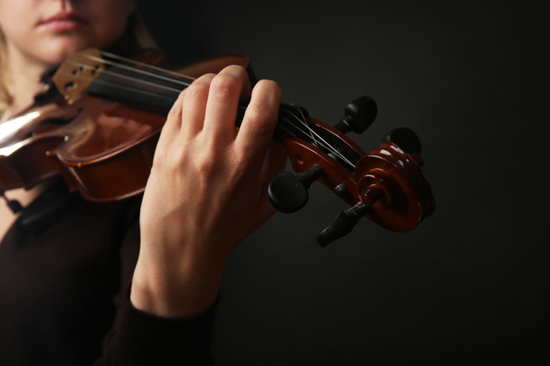 Violinist playing violin on dark background - Fotoğraf, Görsel
