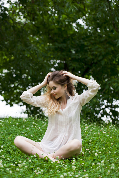 Young blonde woman on green meadow  - Foto, Imagen