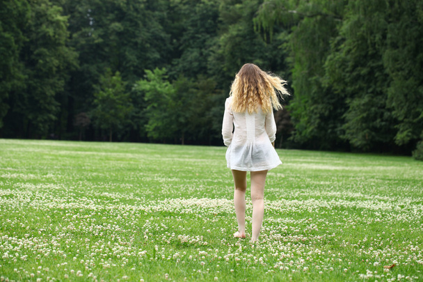 Young beautiful blonde woman walking away - Фото, изображение