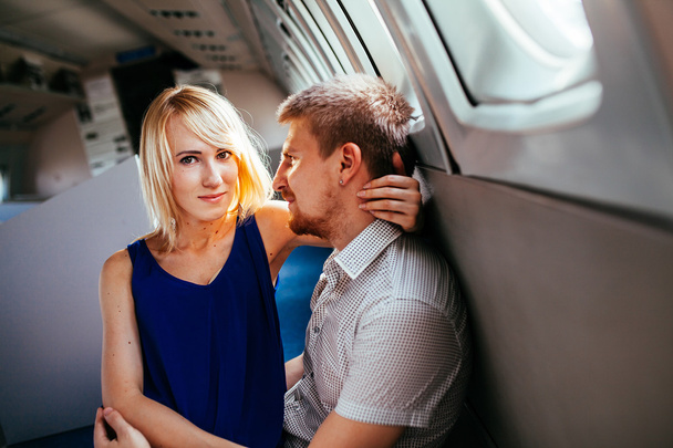 Young couple on board the aircraft - Φωτογραφία, εικόνα