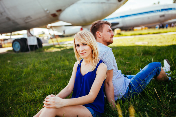 Stylish couple standing near a plane at the airport. honeymoon  - Photo, Image