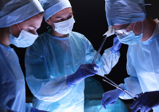Team surgeon at work in operating room. - Foto, afbeelding