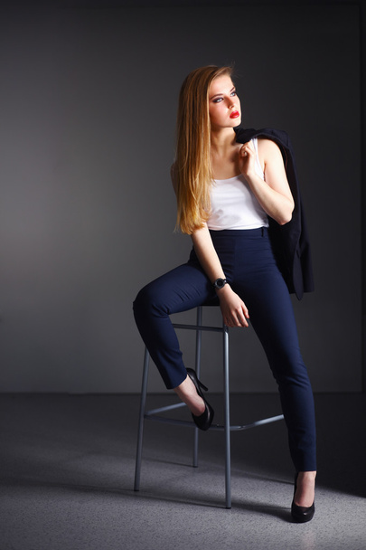 Young woman sitting on a chair - Foto, imagen
