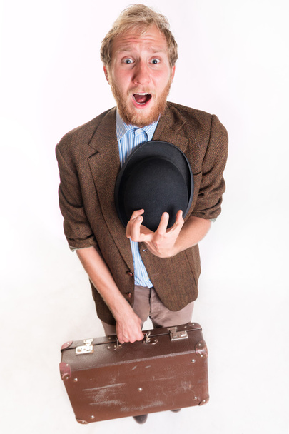 Lost terrified traveler man with a old suitcase - 写真・画像