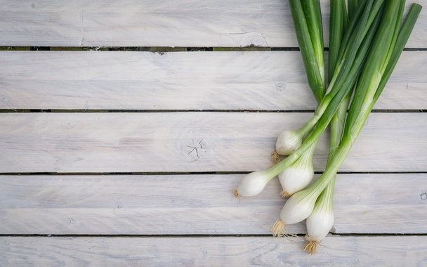 Scallions on a wooden table - Photo, Image