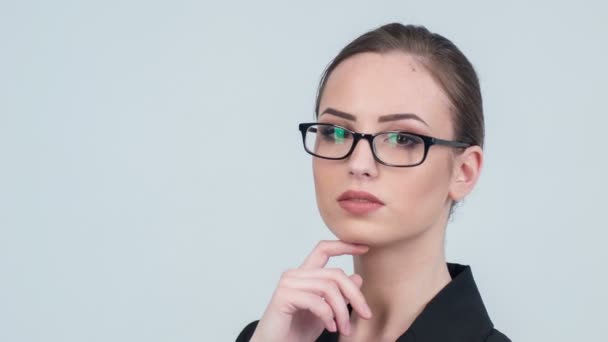 Portrait of woman in glasses thoughtfully posing - Felvétel, videó