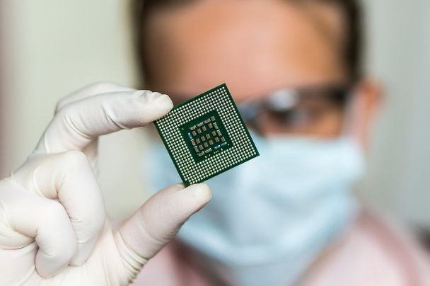 Scientist showing the computer microchip before repairs electron - Φωτογραφία, εικόνα